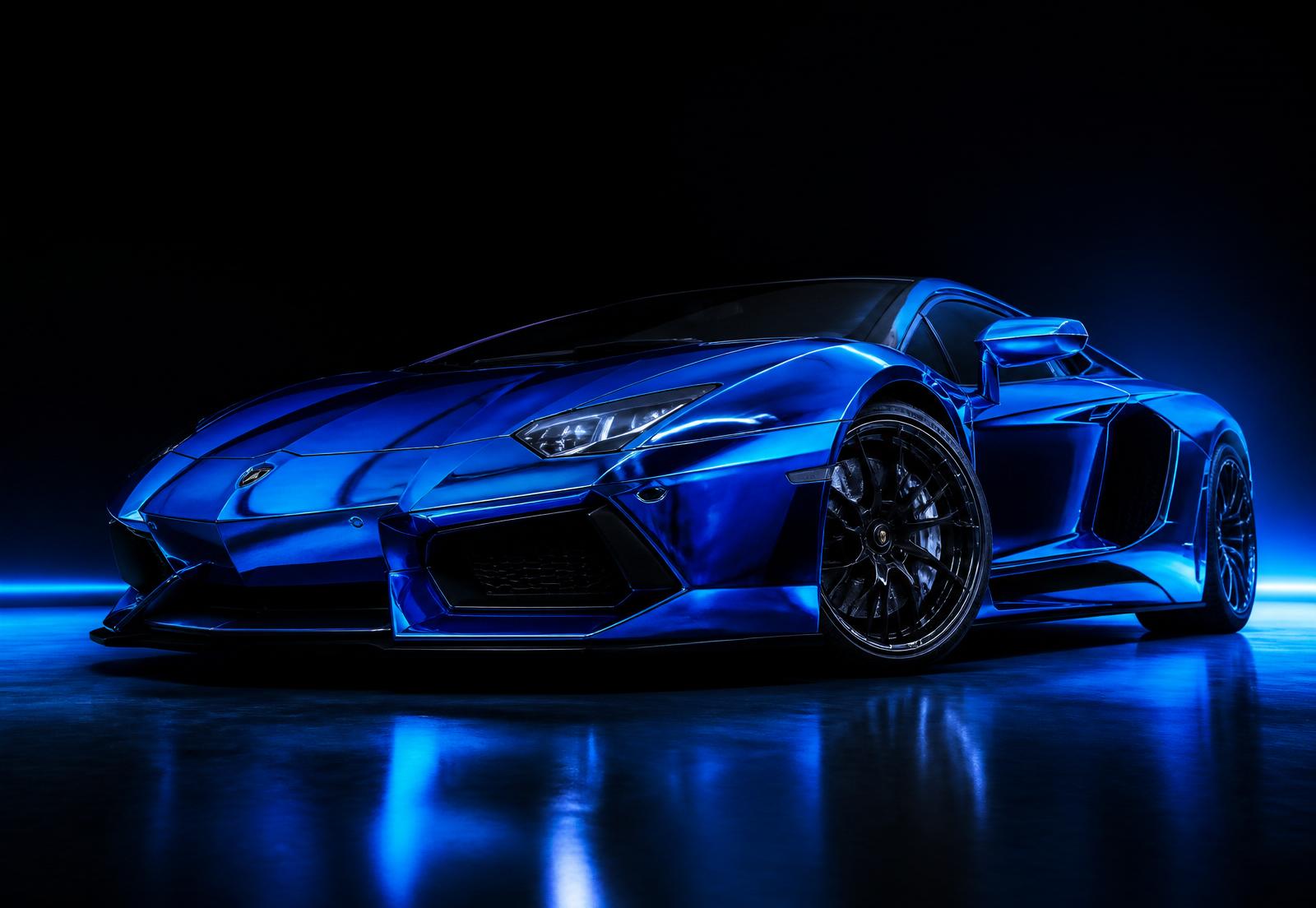 Electric blue chrome wrapped exotic supercar on black studio floor with dramatic rim lighting
